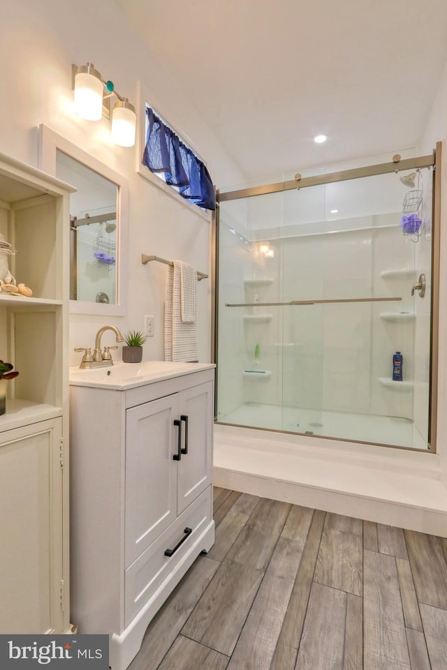 bathroom with vanity and hardwood / wood-style flooring