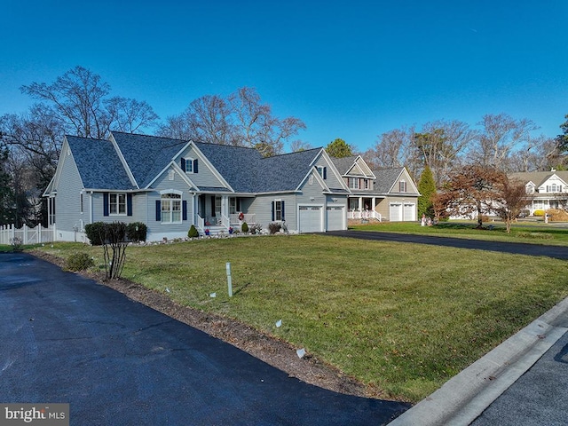 view of front of property with a front yard and a garage