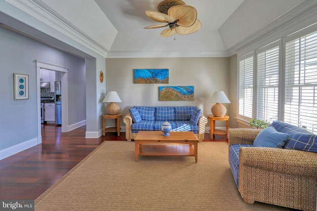 living room with dark hardwood / wood-style floors, ceiling fan, crown molding, and vaulted ceiling