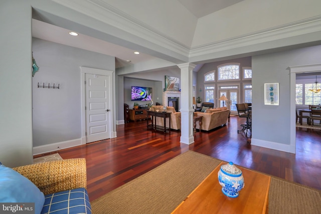 living room with ornamental molding, dark wood-type flooring, and ornate columns