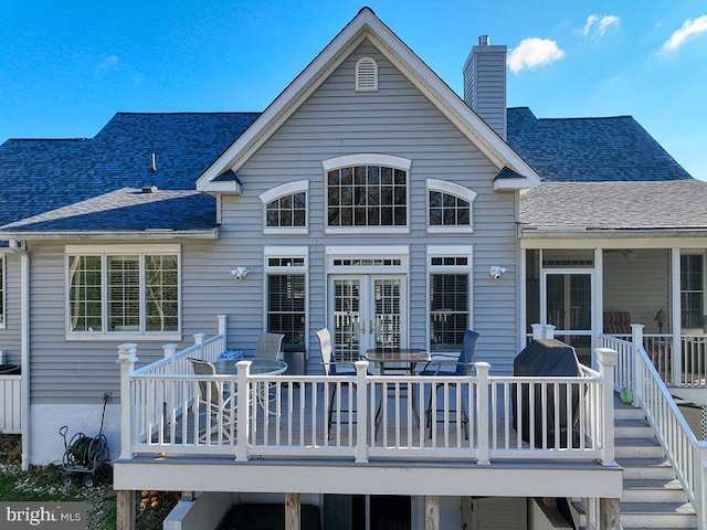 rear view of house featuring french doors and a wooden deck