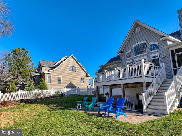 back of house with a yard, a patio area, and a wooden deck