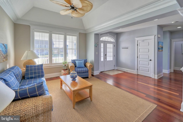 living room featuring hardwood / wood-style flooring, lofted ceiling, ceiling fan, and ornamental molding