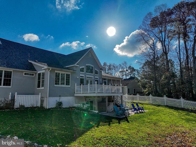 back of house with a lawn and a deck