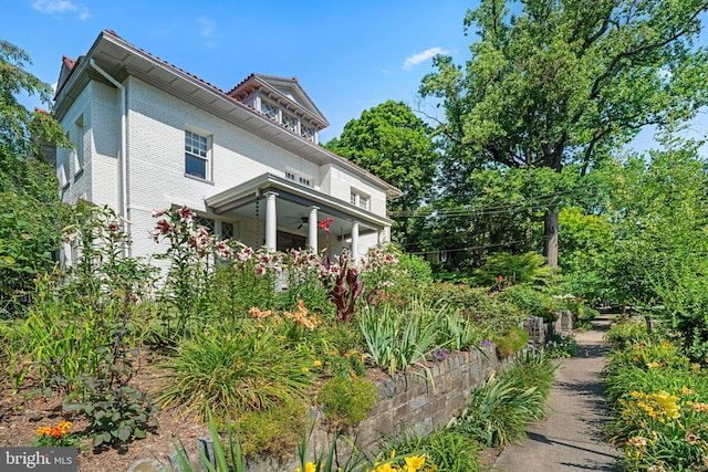 view of side of home with ceiling fan