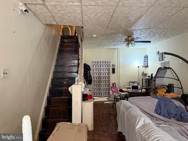 bedroom featuring ceiling fan and dark parquet flooring