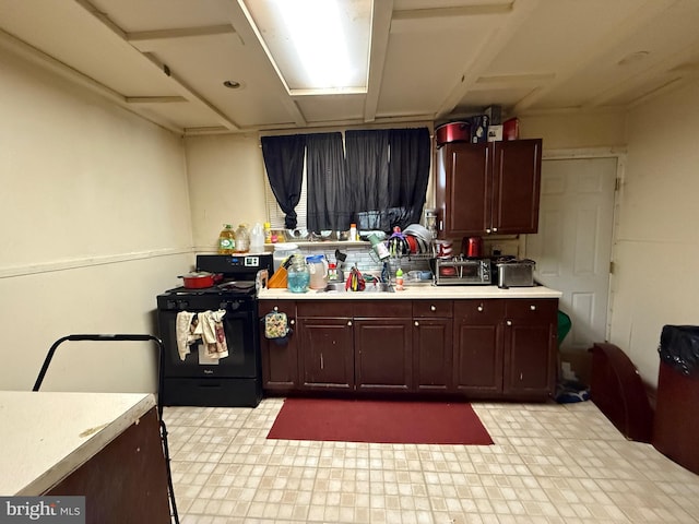 kitchen featuring sink and black electric range oven