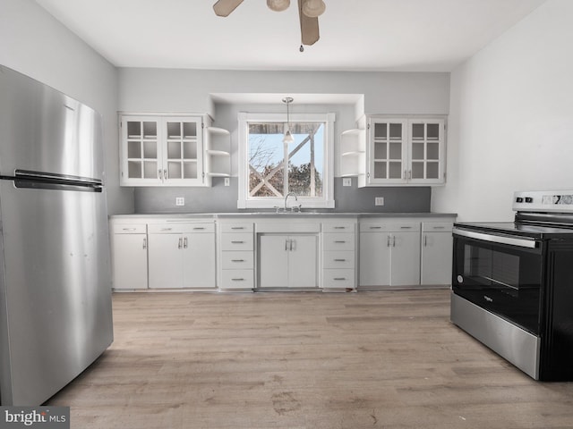 kitchen featuring white cabinets, pendant lighting, and stainless steel appliances