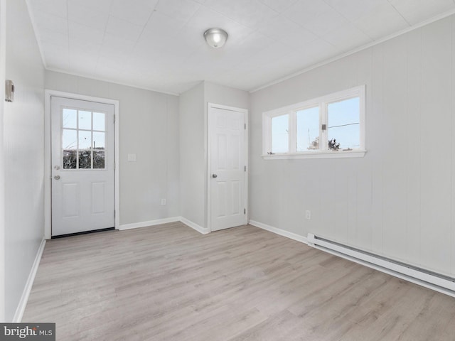 interior space with crown molding, light hardwood / wood-style flooring, and a baseboard radiator