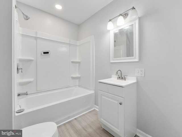 full bathroom featuring shower / tub combination, vanity, hardwood / wood-style flooring, and toilet