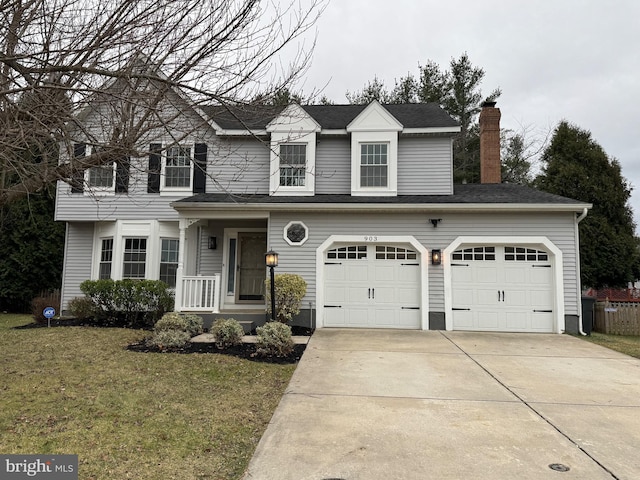 view of front of home with a garage and a front lawn