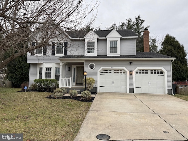 view of front facade with a garage and a front lawn