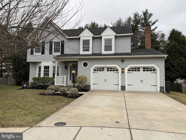 view of front facade with a garage and a front lawn