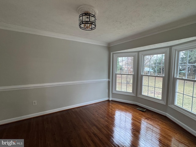 unfurnished room with wood-type flooring, a textured ceiling, and ornamental molding