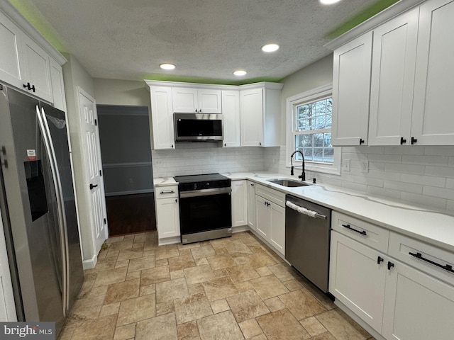 kitchen featuring white cabinets, sink, and stainless steel appliances