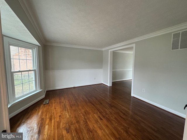 unfurnished room with dark hardwood / wood-style flooring, ornamental molding, and a textured ceiling