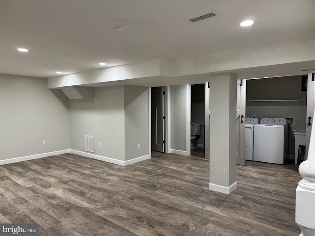 basement featuring dark hardwood / wood-style flooring and independent washer and dryer