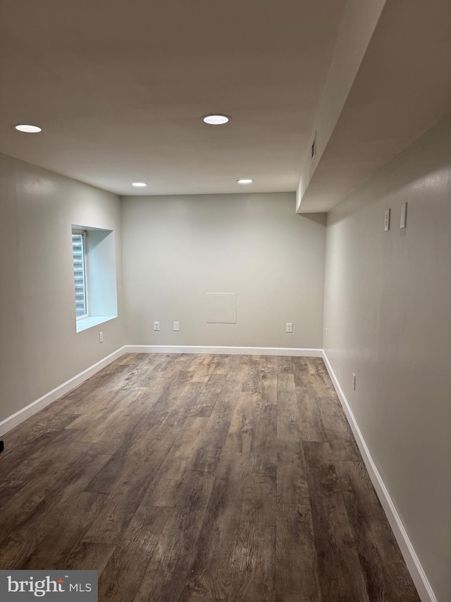 basement featuring dark hardwood / wood-style flooring