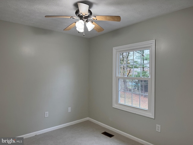 carpeted empty room featuring a textured ceiling and ceiling fan