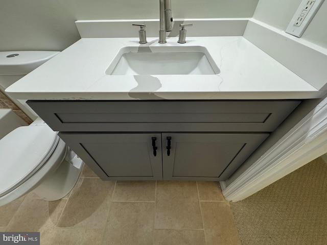 bathroom with tile patterned floors, vanity, and toilet