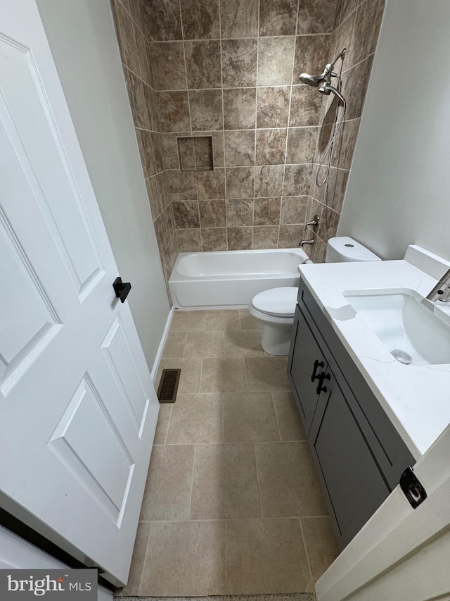 full bathroom with tile patterned floors, toilet, vanity, and tiled shower / bath