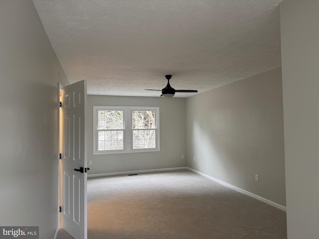 unfurnished room featuring light carpet, a textured ceiling, and ceiling fan