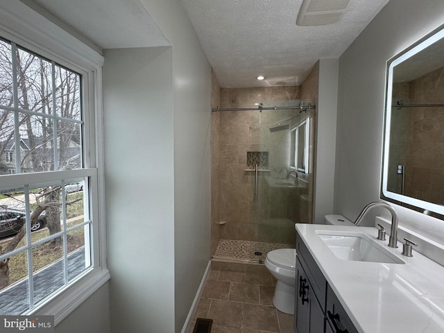 bathroom with toilet, tile patterned flooring, vanity, and walk in shower