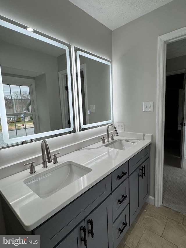 bathroom featuring vanity and a textured ceiling