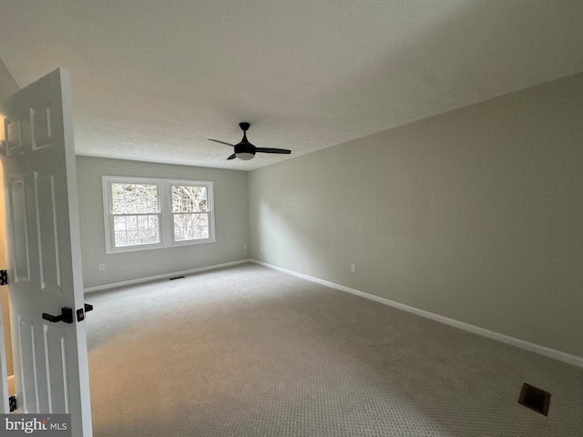 unfurnished room featuring carpet, ceiling fan, and a textured ceiling