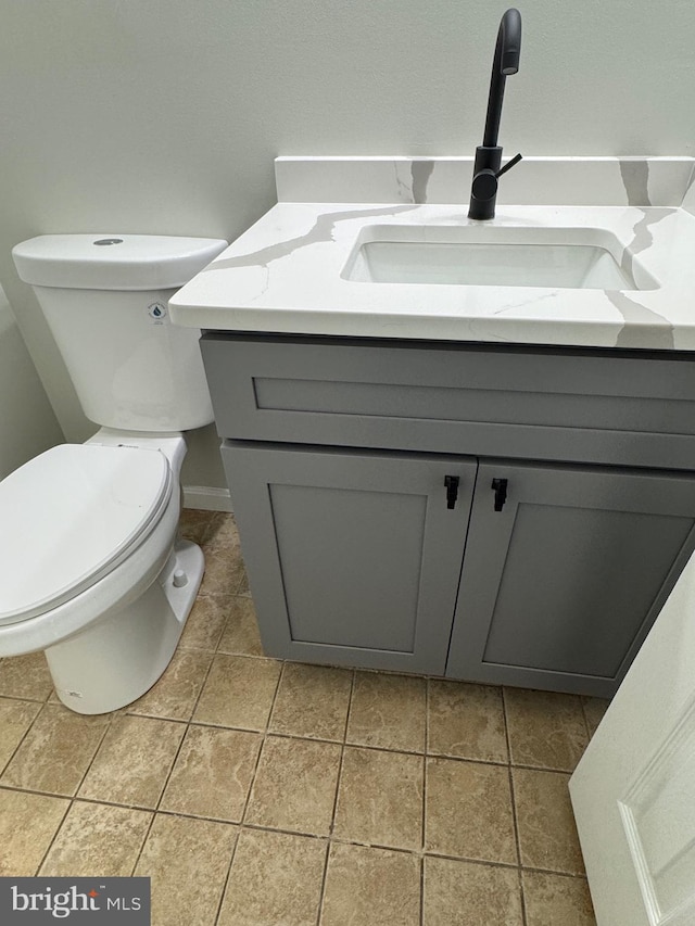 bathroom with tile patterned floors, vanity, and toilet