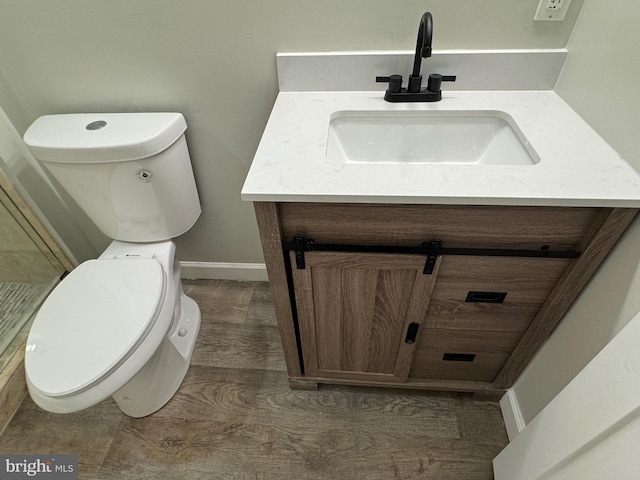 bathroom featuring vanity, toilet, and wood-type flooring