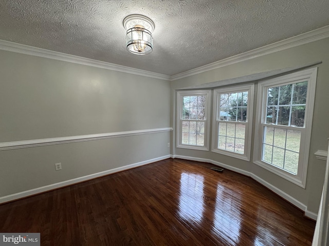 unfurnished room featuring a textured ceiling, crown molding, and dark hardwood / wood-style floors