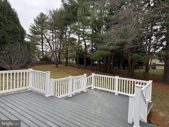 wooden terrace featuring a yard