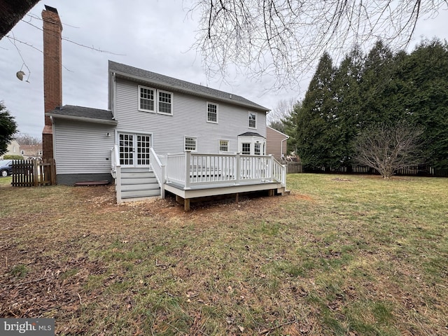 back of house featuring a deck and a yard