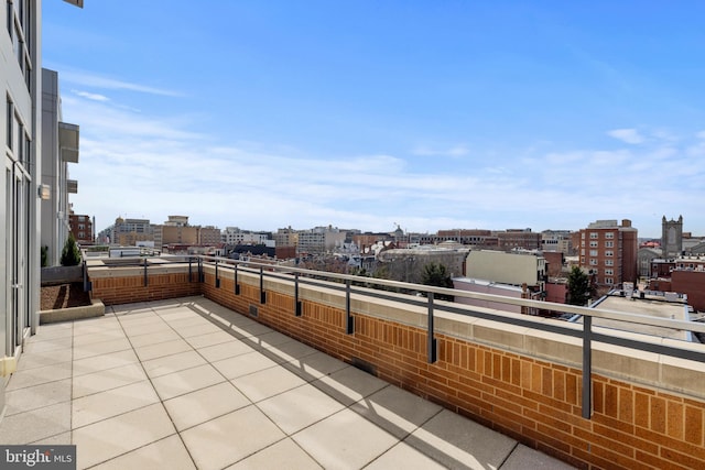 view of patio featuring a view of city and a balcony