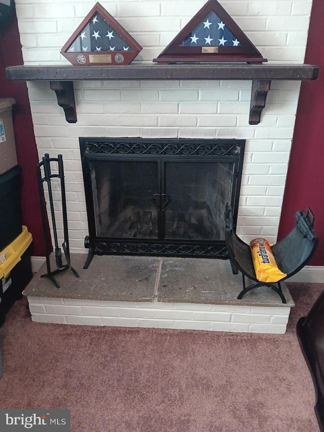 room details with a fireplace and carpet