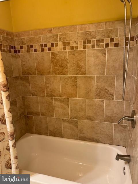 bathroom with shower / bathtub combination with curtain