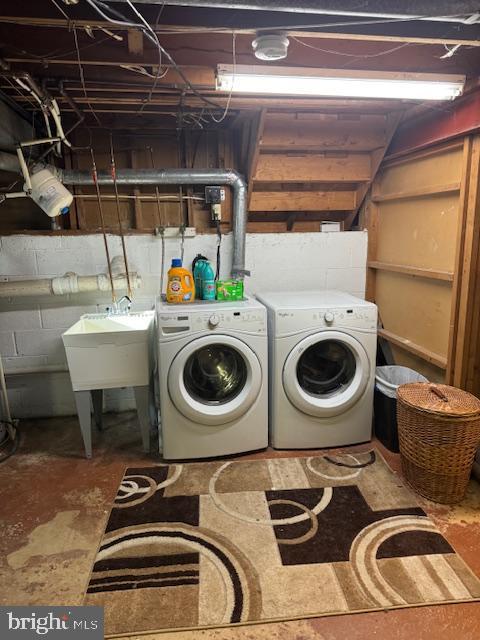 laundry area with washer and dryer and sink