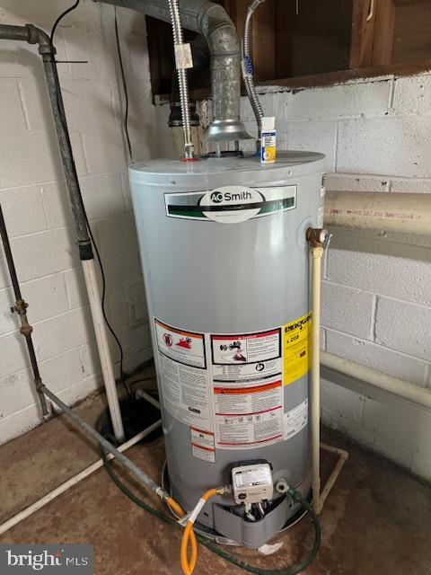 utility room featuring water heater