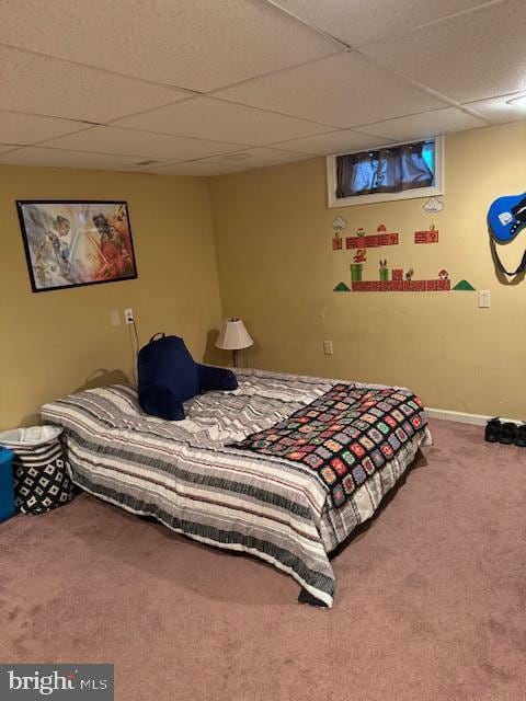 bedroom with a paneled ceiling and carpet floors