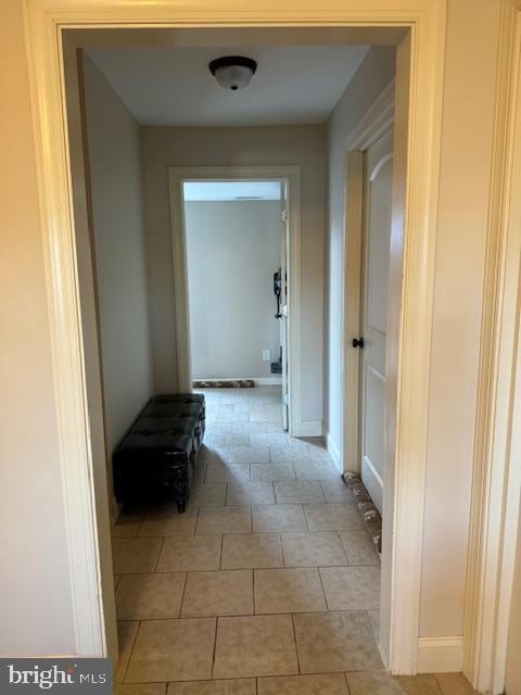 hallway with light tile patterned floors