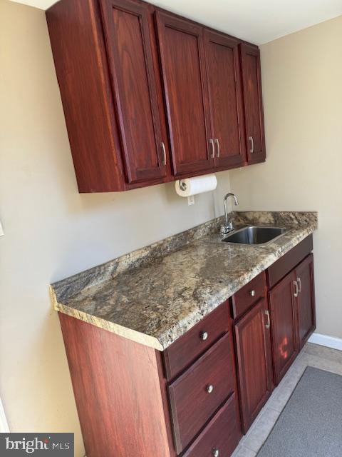 kitchen featuring dark stone countertops and sink