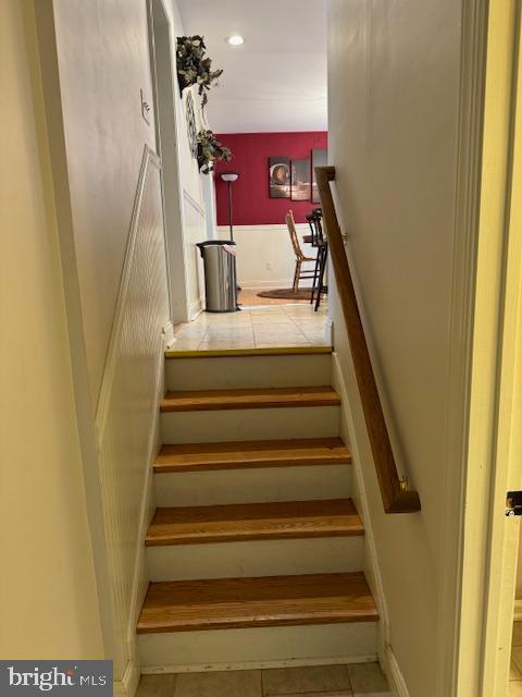 stairway with tile patterned flooring