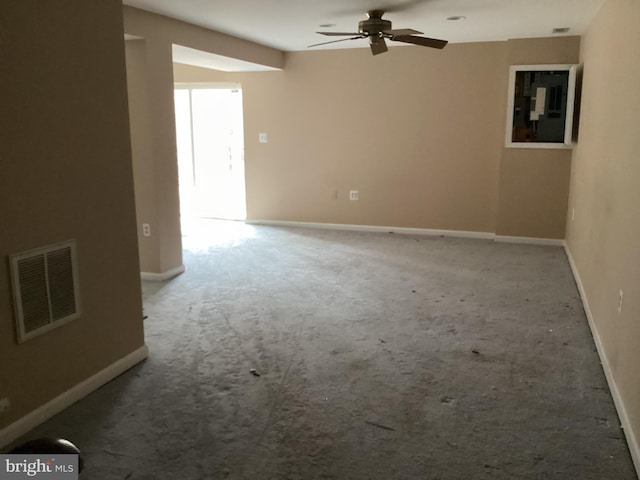 spare room featuring ceiling fan and carpet floors