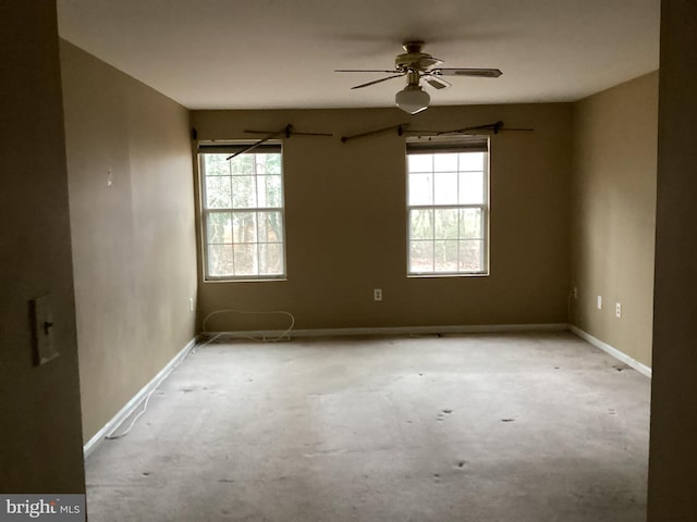 unfurnished room featuring ceiling fan and a wealth of natural light