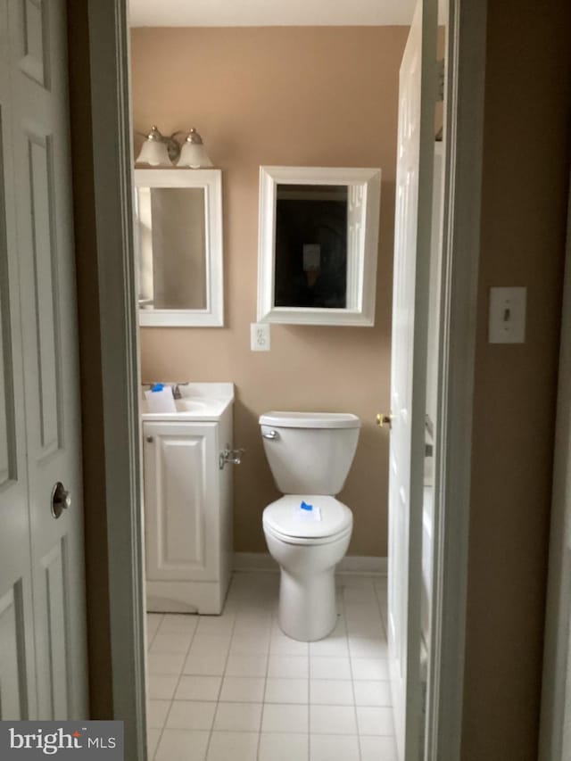 bathroom featuring tile patterned flooring, vanity, and toilet