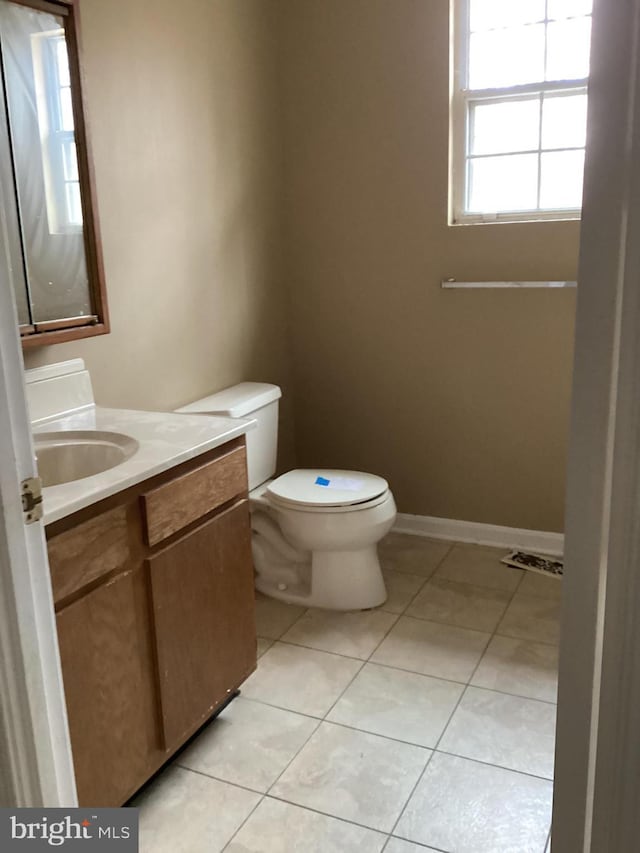 bathroom featuring tile patterned floors, vanity, and toilet