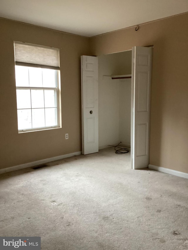 unfurnished bedroom featuring light colored carpet