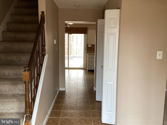 hallway featuring dark tile patterned floors