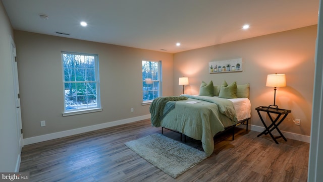 bedroom with dark hardwood / wood-style flooring